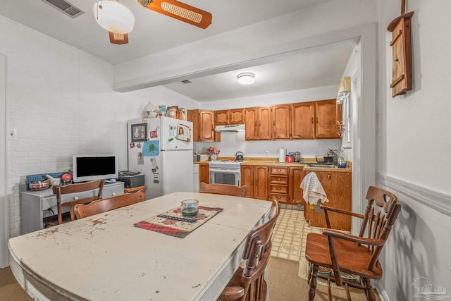 kitchen featuring sink, white fridge, ceiling fan, stainless steel range oven, and beam ceiling