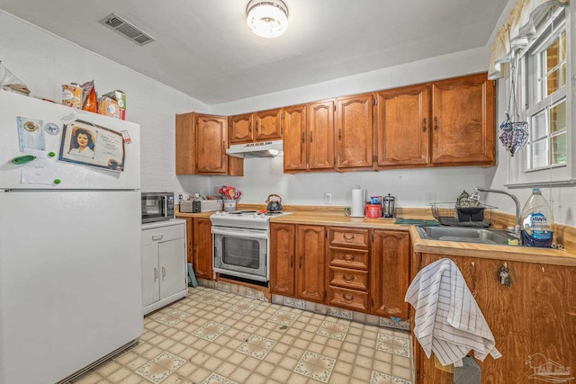 kitchen with sink and white appliances