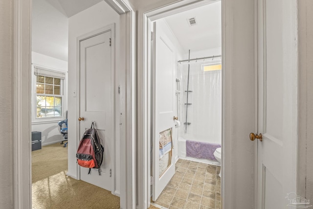 bathroom featuring toilet and tub / shower combination