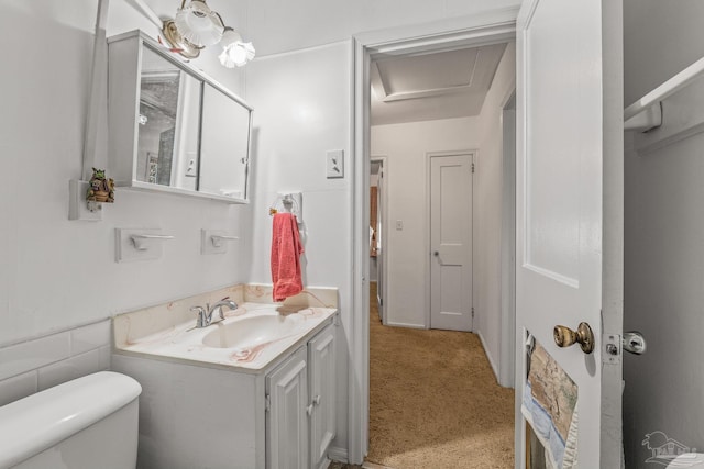 bathroom featuring vanity and toilet