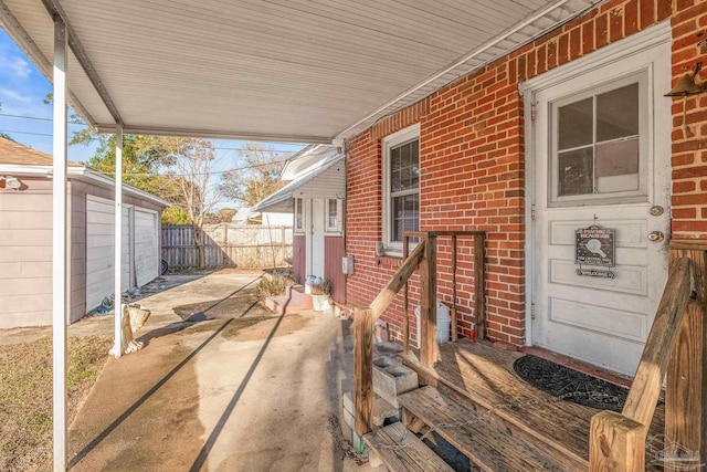 view of patio featuring a garage and an outbuilding