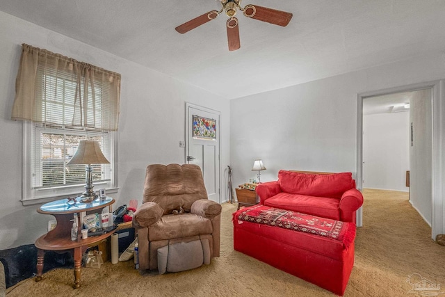 carpeted living room featuring ceiling fan