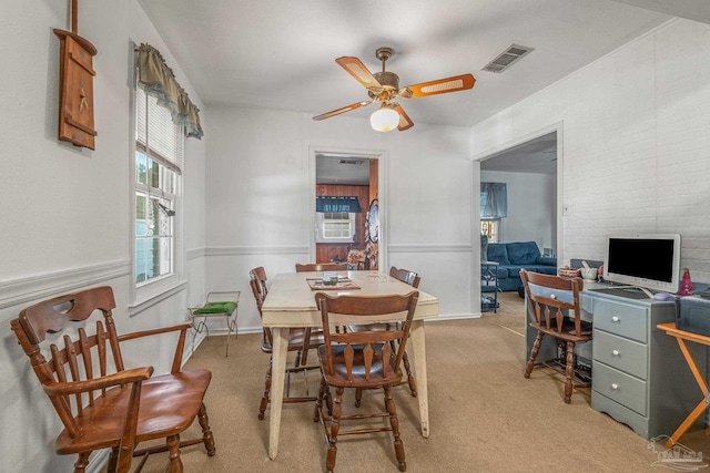 dining area with light carpet and ceiling fan