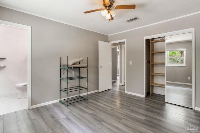 6845 Trail Ride S, Milton, FL 32570 - unfurnished bedroom featuring wood finished floors, ornamental molding, baseboards, a closet, and ensuite bath