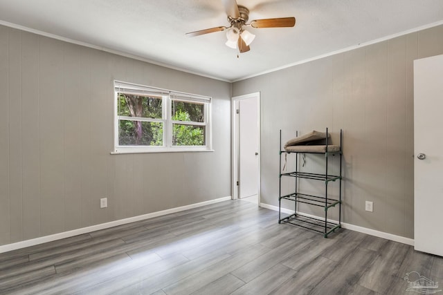 6845 Trail Ride S, Milton, FL 32570 - spare room featuring a ceiling fan, wood finished floors, crown molding, and baseboards