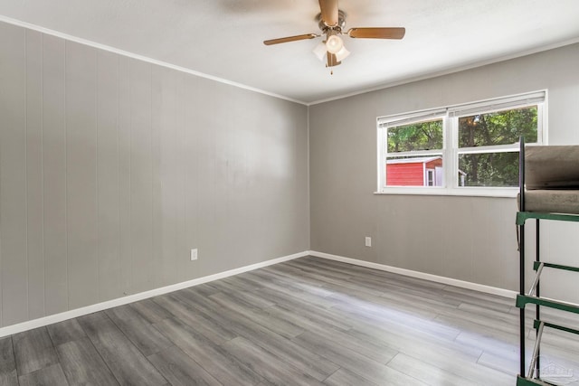 6845 Trail Ride S, Milton, FL 32570 - unfurnished room featuring wood finished floors, ceiling fan, baseboards, and crown molding