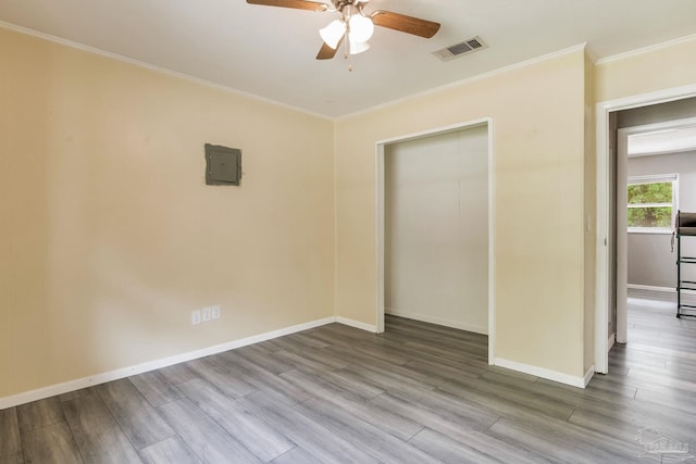 6845 Trail Ride S, Milton, FL 32570 - spare room featuring ceiling fan, wood finished floors, electric panel, ornamental molding, and baseboards