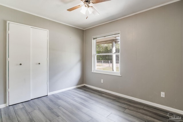 6845 Trail Ride S, Milton, FL 32570 - unfurnished bedroom featuring wood finished floors, ornamental molding, baseboards, a closet, and a ceiling fan