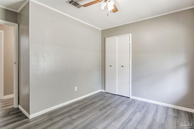 6845 Trail Ride S, Milton, FL 32570 - unfurnished bedroom featuring wood finished floors, crown molding, a closet, baseboards, and ceiling fan