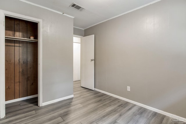 6845 Trail Ride S, Milton, FL 32570 - unfurnished bedroom featuring wood finished floors, crown molding, a closet, and baseboards