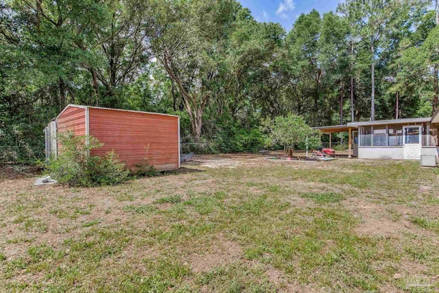 6845 Trail Ride S, Milton, FL 32570 - view of grassy yard featuring an outbuilding, a sunroom, and a shed