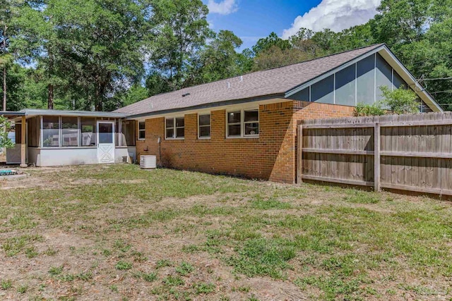 6845 Trail Ride S, Milton, FL 32570 - back of house with a sunroom, brick siding, and an attached garage