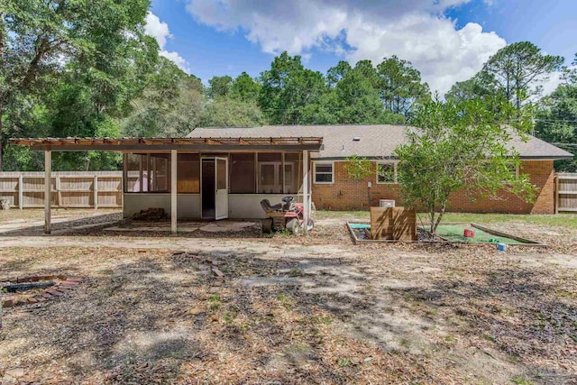 6845 Trail Ride S, Milton, FL 32570 - back of property with a sunroom, fence, and brick siding
