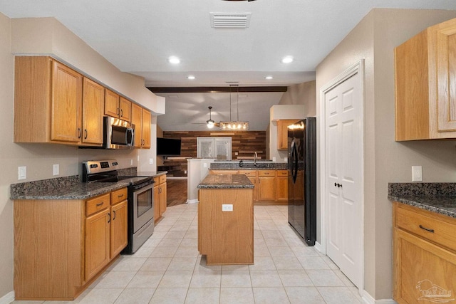 kitchen featuring a ceiling fan, visible vents, a kitchen island, appliances with stainless steel finishes, and open floor plan