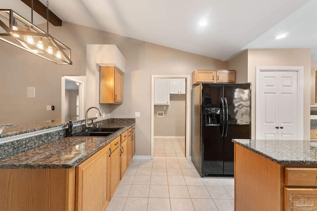 kitchen with black fridge with ice dispenser, dark stone counters, lofted ceiling, and a sink