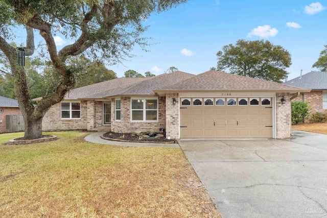 single story home featuring brick siding, an attached garage, a front yard, roof with shingles, and driveway