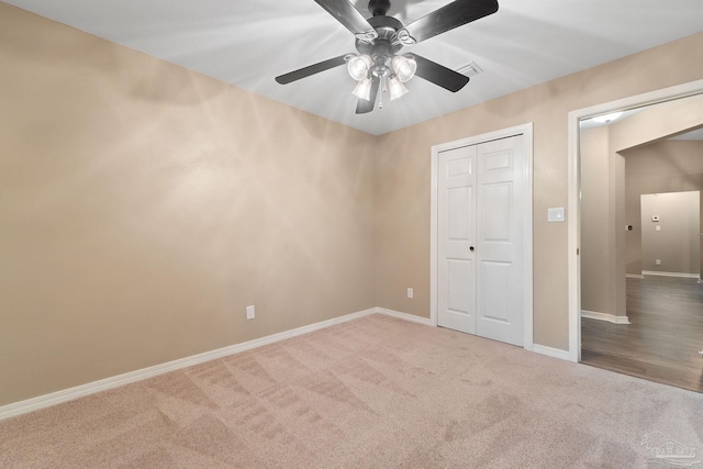 unfurnished bedroom featuring visible vents, baseboards, carpet floors, a closet, and a ceiling fan