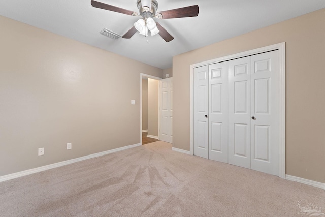 unfurnished bedroom with carpet flooring, baseboards, visible vents, and ceiling fan