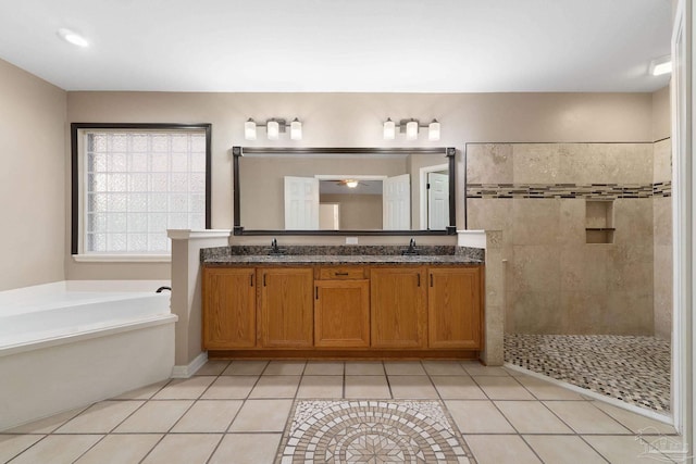 full bath with a walk in shower, double vanity, a bath, tile patterned floors, and a sink