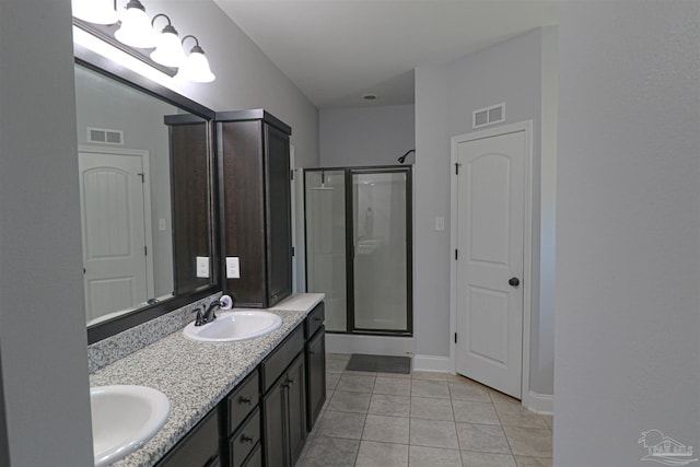 bathroom featuring vanity, tile patterned flooring, and an enclosed shower