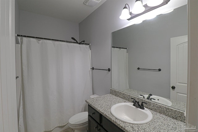 bathroom with toilet and vanity