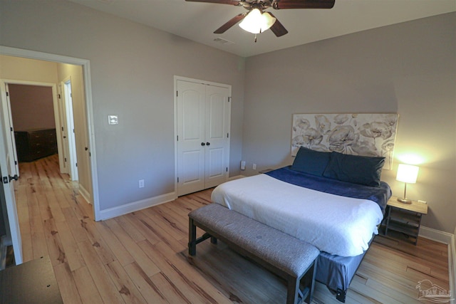 bedroom featuring ceiling fan, a closet, and light wood-type flooring