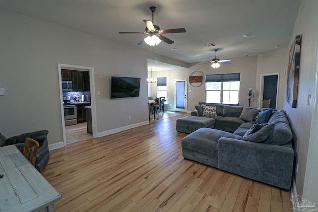 living room with ceiling fan and light wood-type flooring