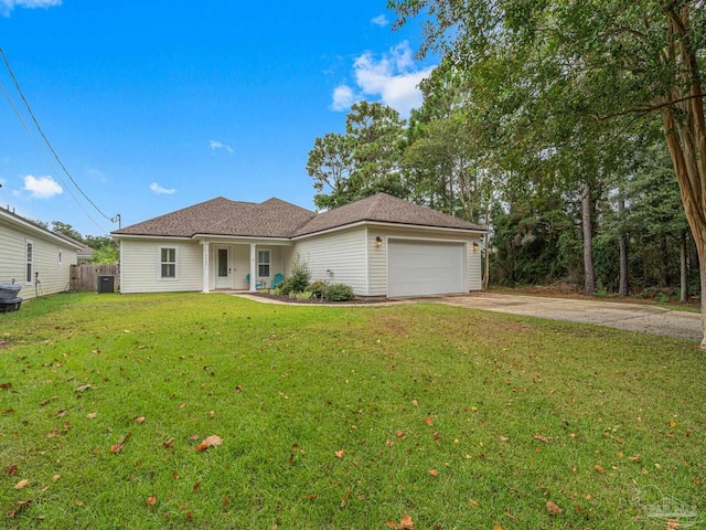 view of front of property with a garage, central AC unit, and a front lawn