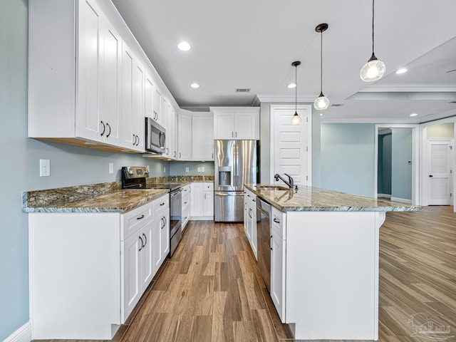 kitchen with decorative light fixtures, light hardwood / wood-style flooring, stone countertops, stainless steel appliances, and white cabinetry