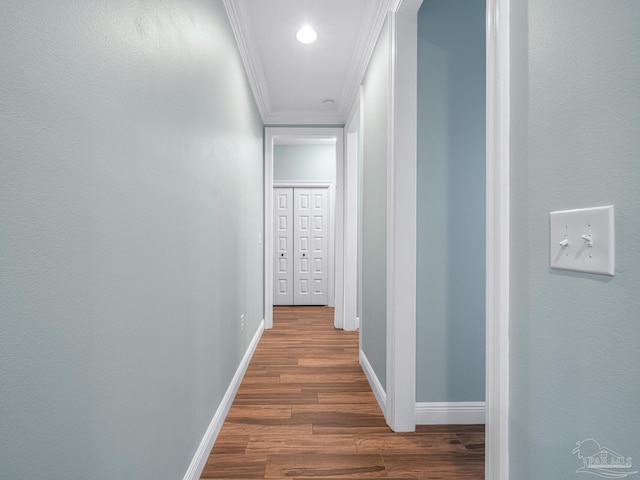 hall featuring ornamental molding and dark wood-type flooring