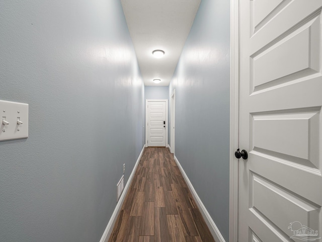 hallway with dark hardwood / wood-style flooring