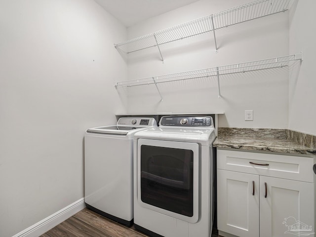 washroom with washer and clothes dryer and dark hardwood / wood-style floors