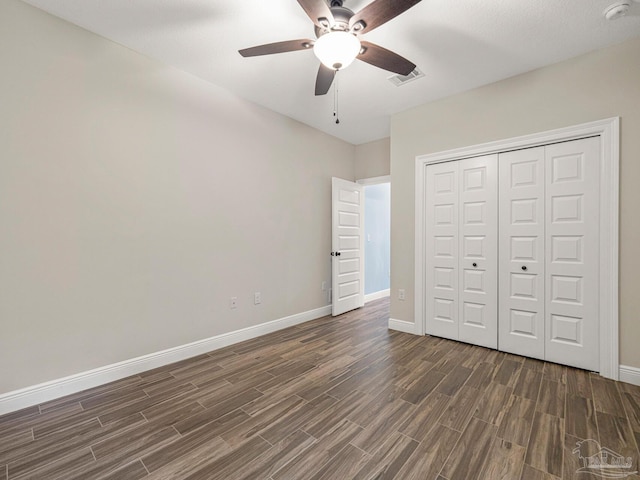 unfurnished bedroom featuring a closet, ceiling fan, and dark hardwood / wood-style flooring