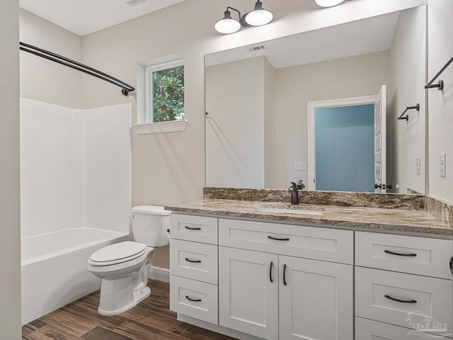 full bathroom with vanity, toilet, hardwood / wood-style flooring, and shower / bathing tub combination