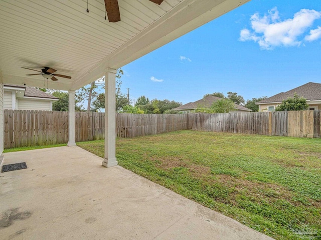 view of yard featuring ceiling fan and a patio area