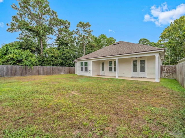 back of house with a yard and a patio area