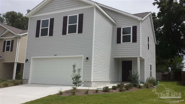 view of front of property featuring a front lawn and a garage