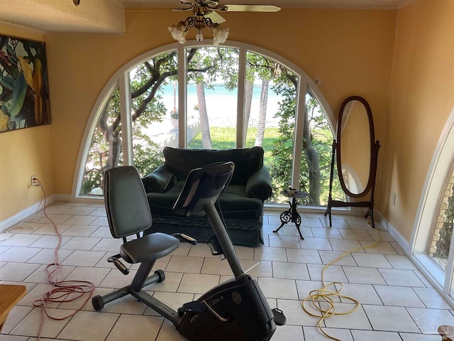 interior space with light tile patterned floors, ceiling fan, and a healthy amount of sunlight