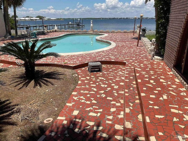 view of pool featuring a water view