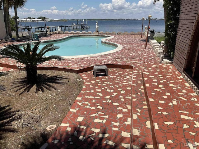 view of swimming pool with a water view and a patio area