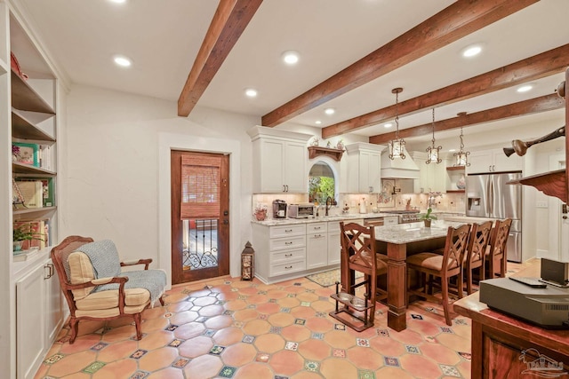 dining room with sink and beam ceiling