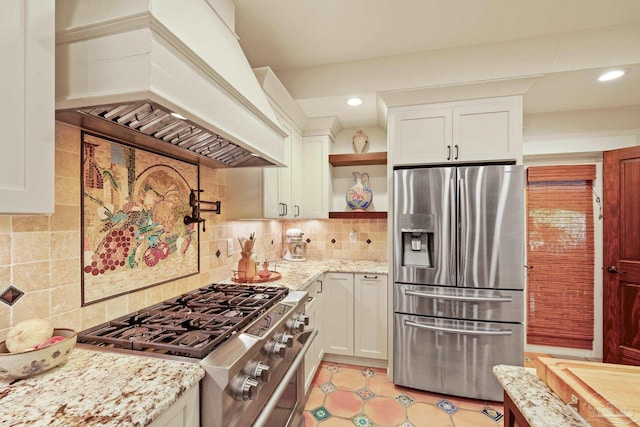 kitchen with stainless steel refrigerator with ice dispenser, custom range hood, and white cabinets