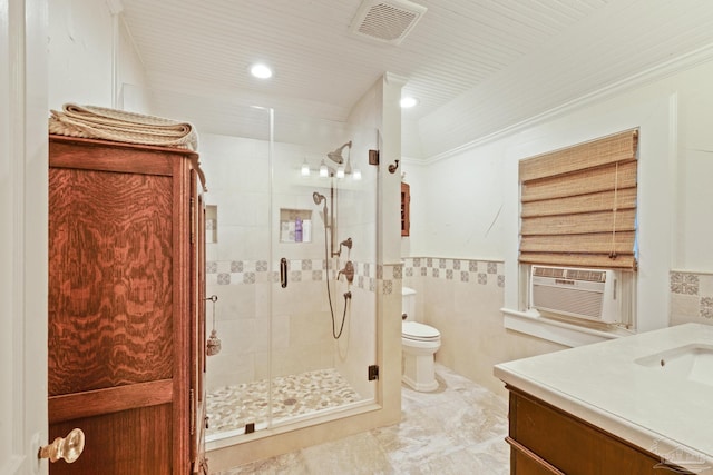 bathroom featuring cooling unit, tile walls, vanity, a shower with shower door, and toilet