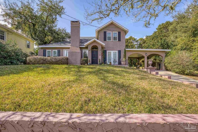 view of front of home with a front lawn and french doors