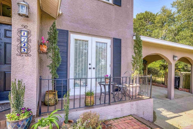 entrance to property featuring a patio area and french doors