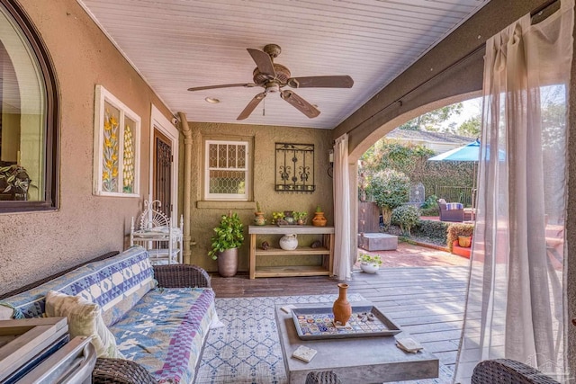 exterior space with ceiling fan and an outdoor living space