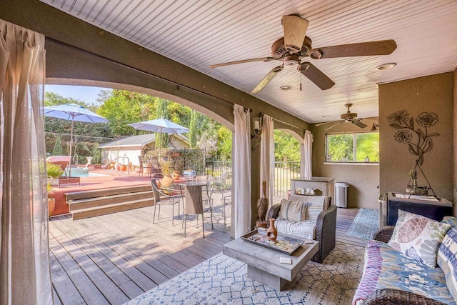 wooden terrace featuring ceiling fan