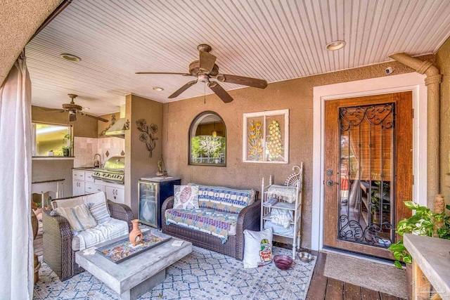 view of patio with ceiling fan, an outdoor fire pit, grilling area, and sink