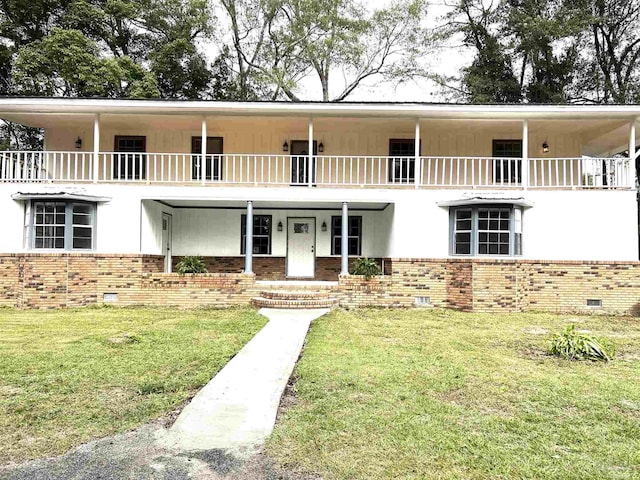 view of front of house with a front yard and a balcony