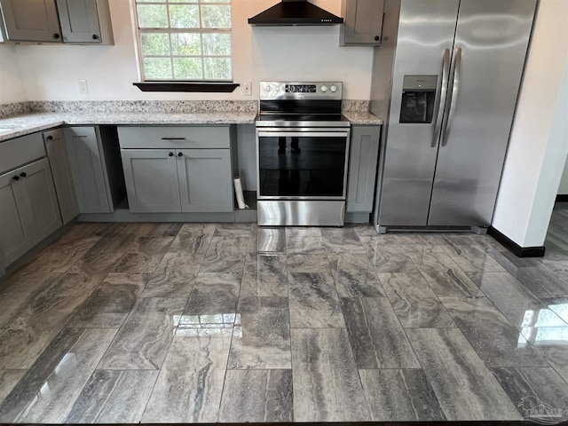 kitchen featuring range hood, stainless steel appliances, gray cabinetry, and light stone countertops